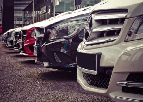 Front of a line-up of cars at a dealership.