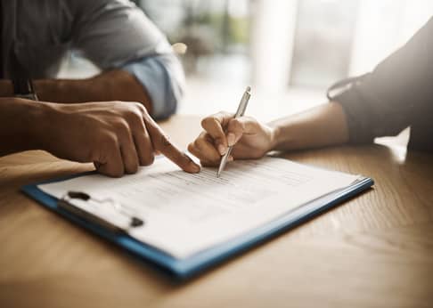 Person signing a legal document.