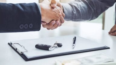 People shaking hands after agreeing a deal.